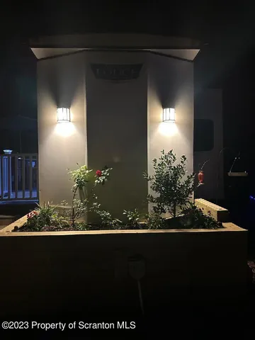 a living room with furniture a flat screen tv and a floor to ceiling window