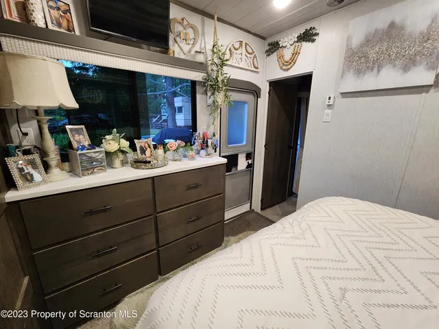 a bathroom with a sink a toilet a mirror and shower