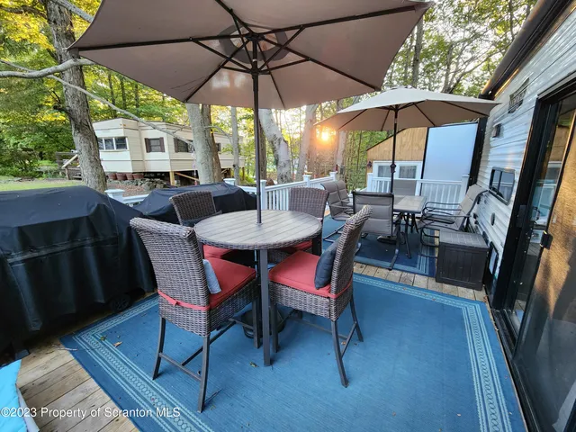 a view of a patio with table and chairs under an umbrella