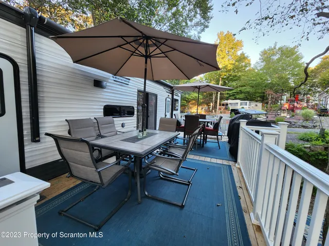 a view of a patio with two couches next to a yard