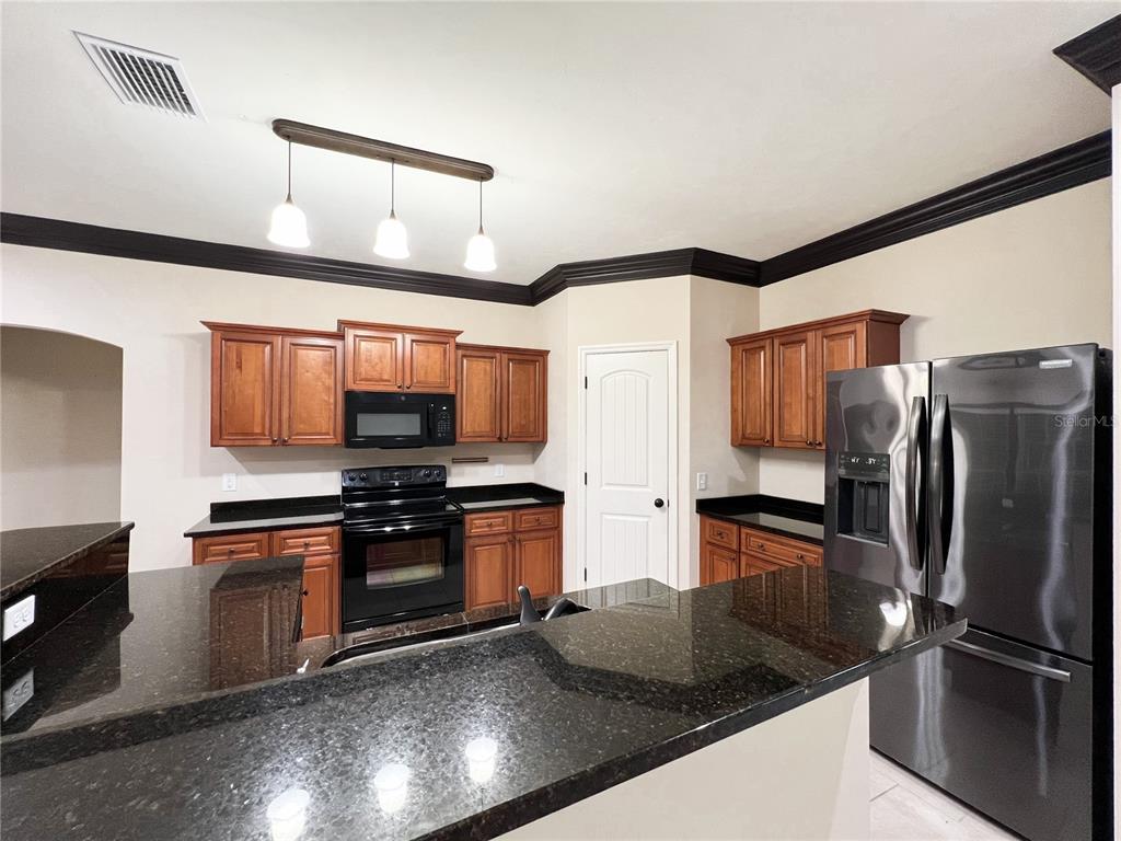 19176 Northwest 228th Street High Springs, FL 32643 - Photo 18 of 68 a kitchen with stainless steel appliances granite countertop a refrigerator and a stove