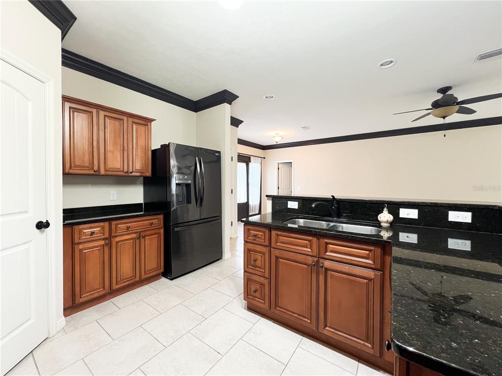 19176 Northwest 228th Street High Springs, FL 32643 - Photo 20 of 68 a kitchen with stainless steel appliances granite countertop a refrigerator and a stove top oven