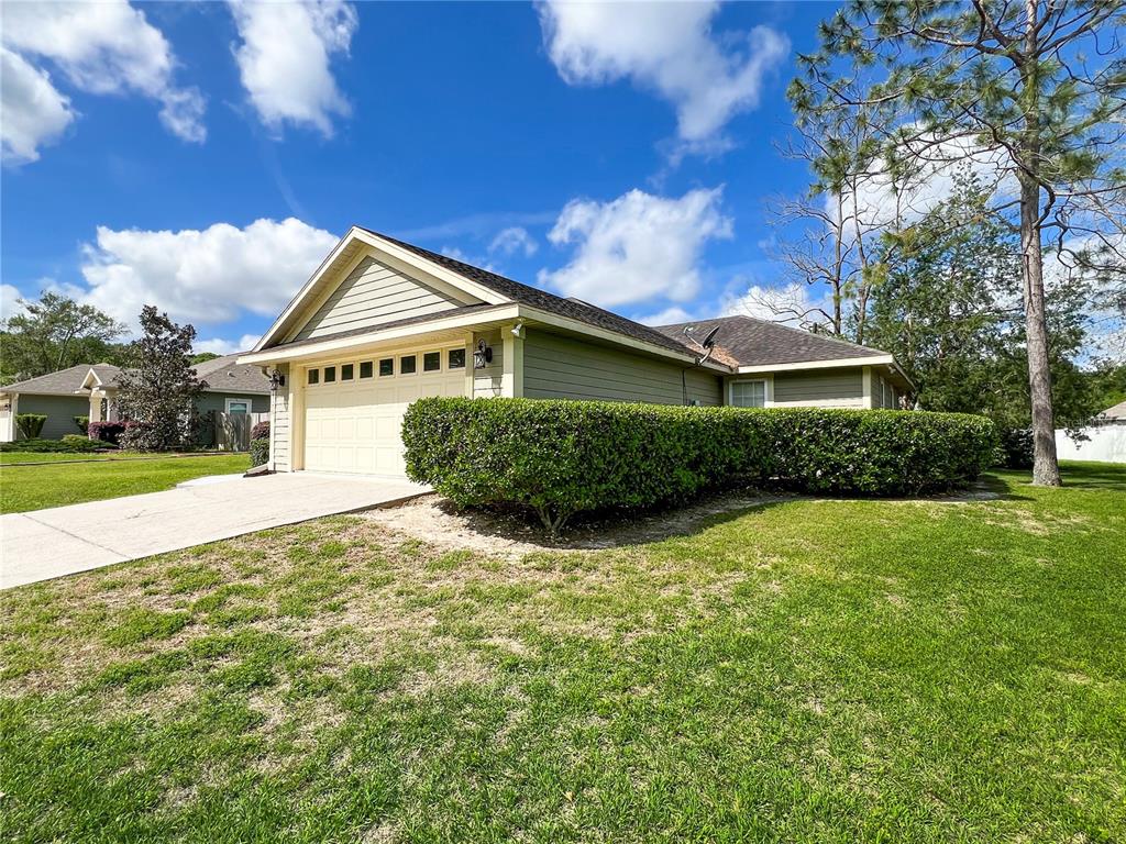19176 Northwest 228th Street High Springs, FL 32643 - Photo 3 of 68 a front view of a house with a yard