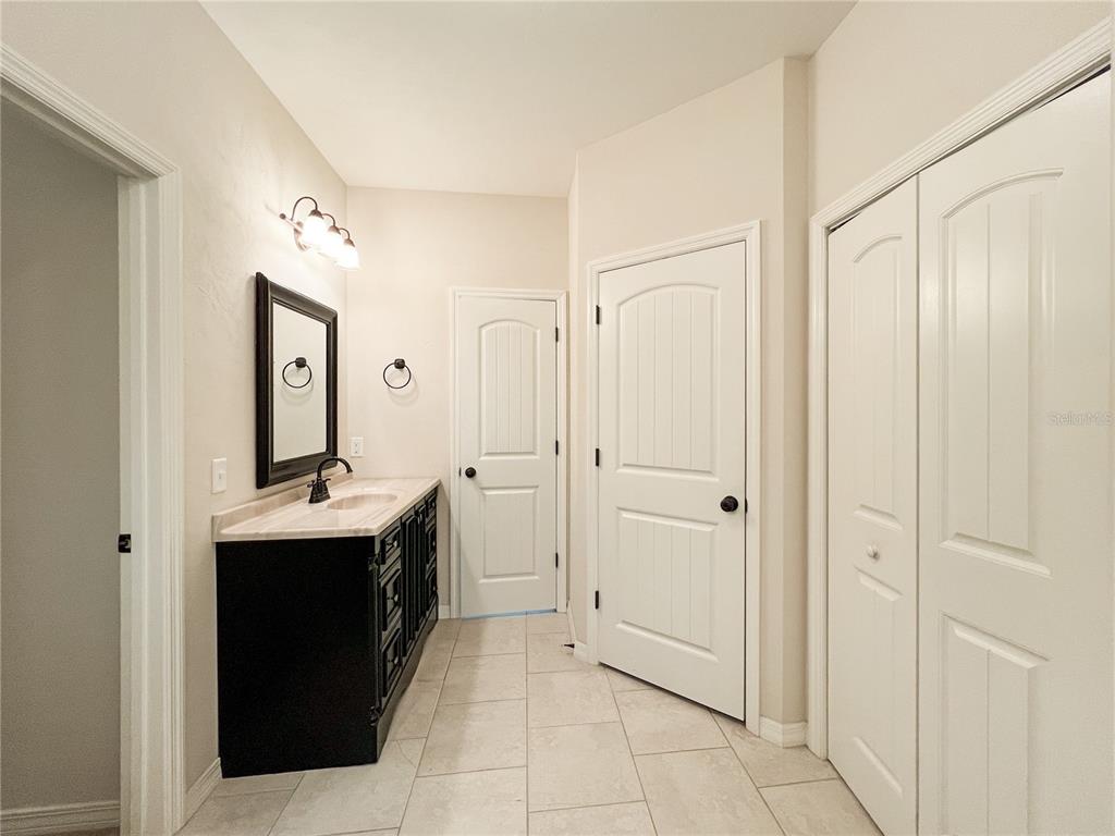 19176 Northwest 228th Street High Springs, FL 32643 - Photo 35 of 68 a spacious bathroom with a double vanity sink and a mirror
