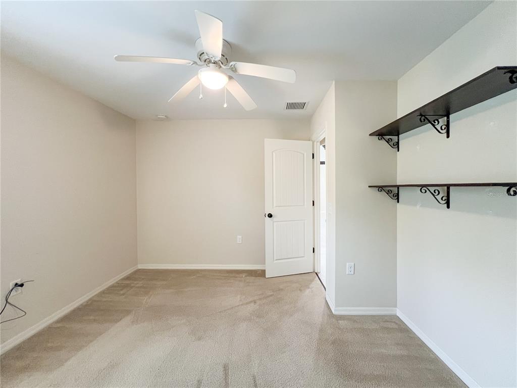 19176 Northwest 228th Street High Springs, FL 32643 - Photo 45 of 68 an empty room with a ceiling fan and a window