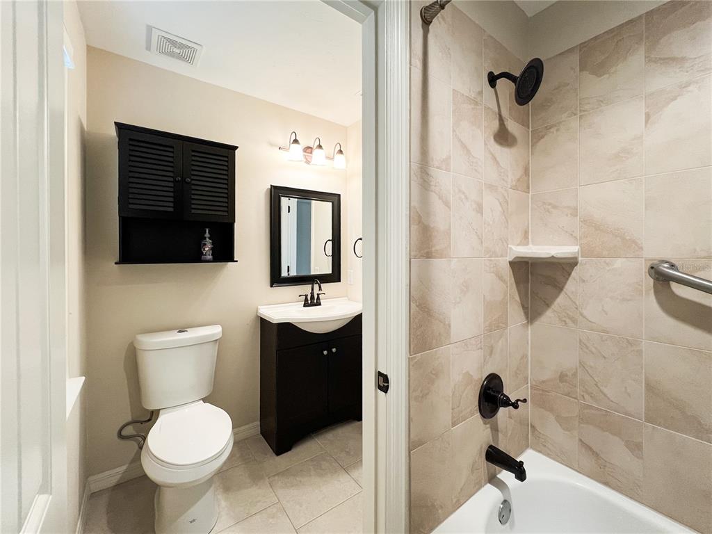 19176 Northwest 228th Street High Springs, FL 32643 - Photo 50 of 68 a bathroom with a toilet sink and shower