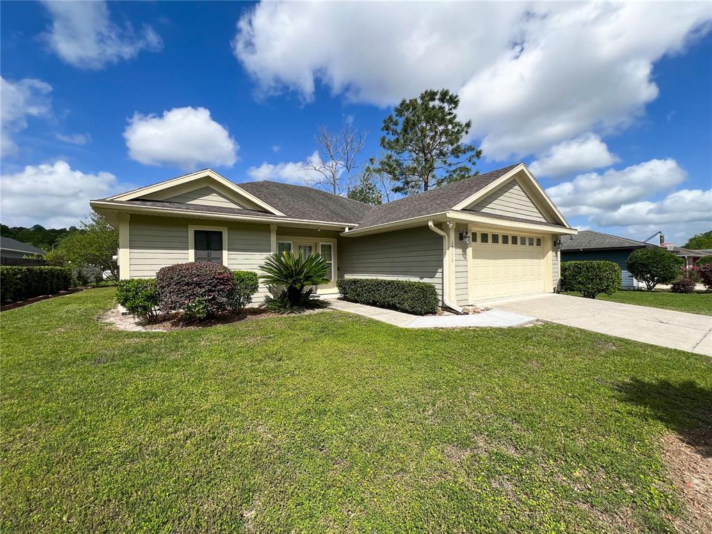 19176 Northwest 228th Street High Springs, FL 32643 - Photo 5 of 68 a front view of a house with a yard and garage