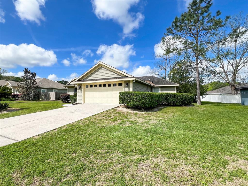 19176 Northwest 228th Street High Springs, FL 32643 - Photo 60 of 68 a front view of a house with a yard