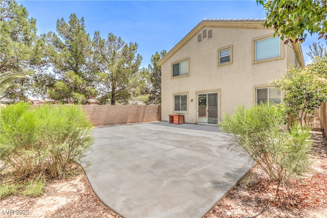585 Foster Springs Road Las Vegas, NV 89148 - Photo 35 of 39 Rear view of property with stucco siding, a fenced backyard, and a patio