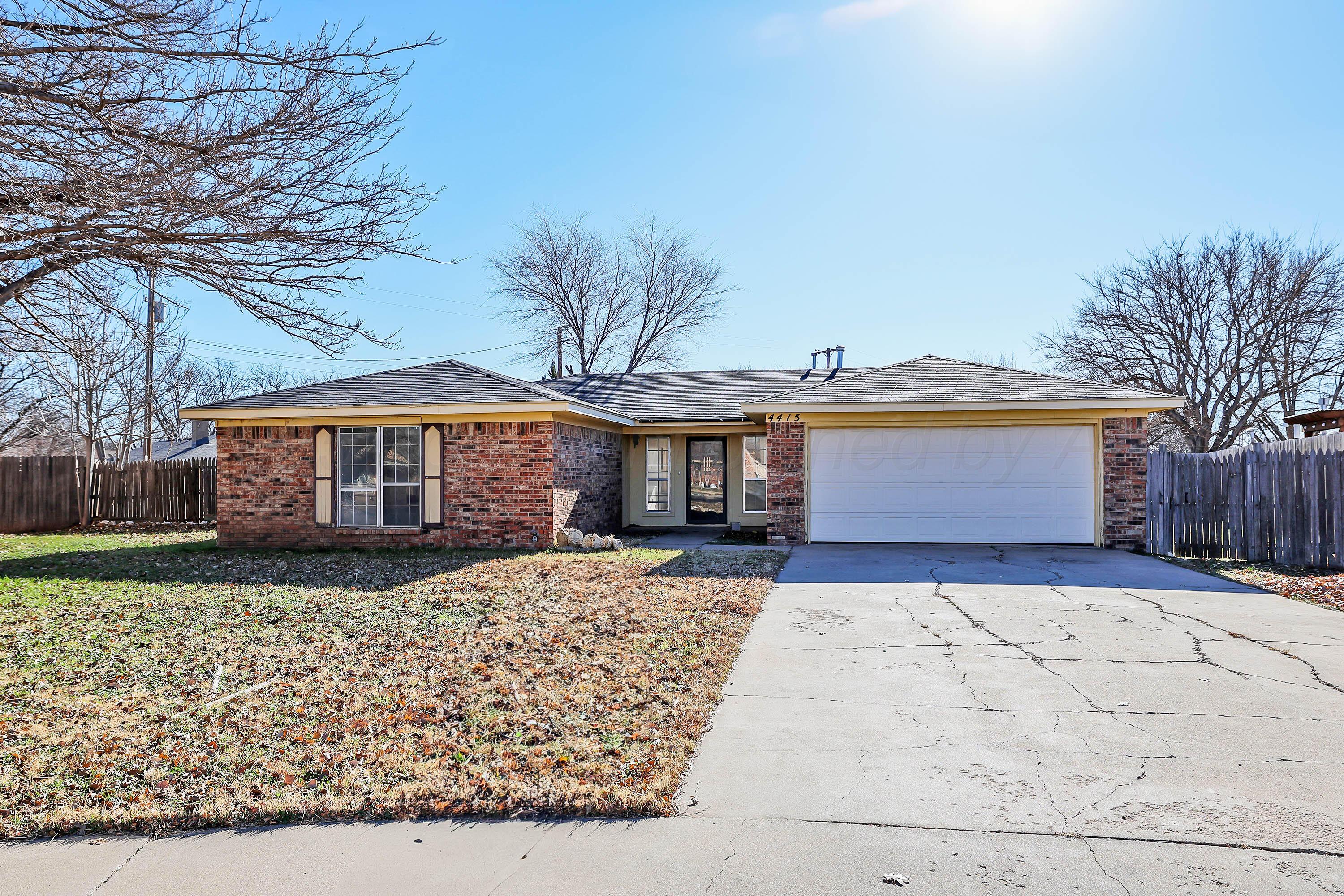 4415 Kingston Road Amarillo, TX 79109 - Photo 1 of 28 a front view of a house with garden