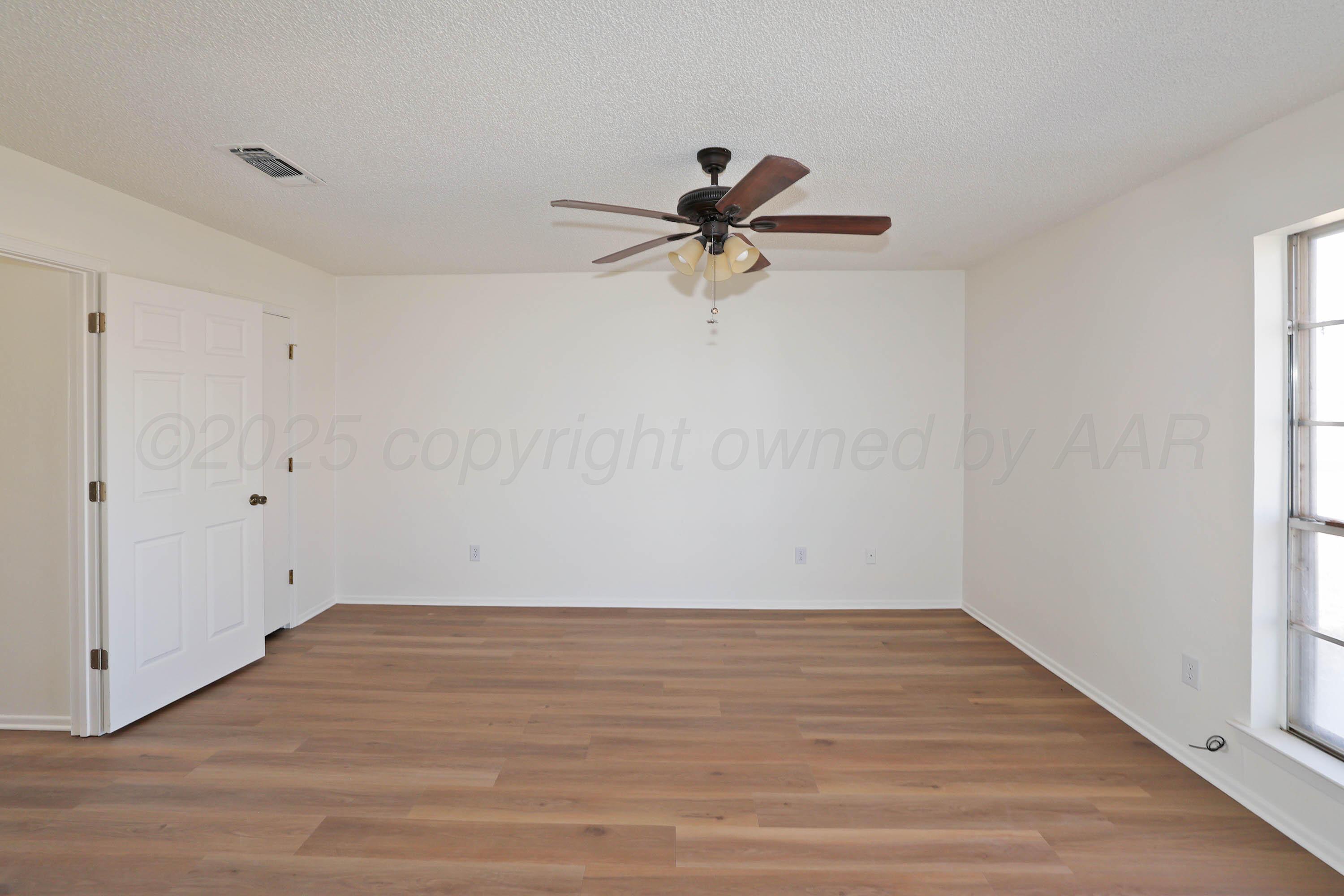 4415 Kingston Road Amarillo, TX 79109 - Photo 12 of 28 a view of a room with wooden floor and a ceiling fan