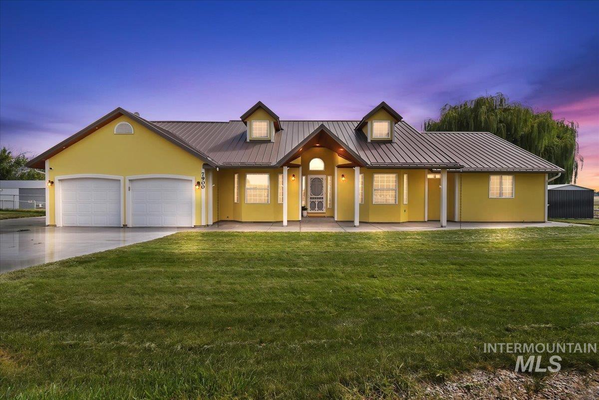7900 Labor Camp Road Caldwell, ID 83607 - Photo 2 of 45 Exterior featuring a metal roof, dormer windows, covered entry, and an attached two-car garage
