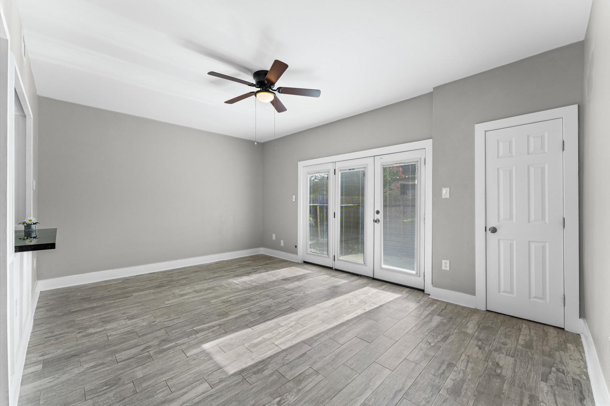 830 Threadneedle Street, Unit 240 Houston, TX 77079 - Photo 10 of 24 17x12 Family Room! Newer double glass French doors opening to the exterior patio. The door to the right leads into the "indoor" laundry room. The two spaces downstairs are inviting, spacious and nicely redone.