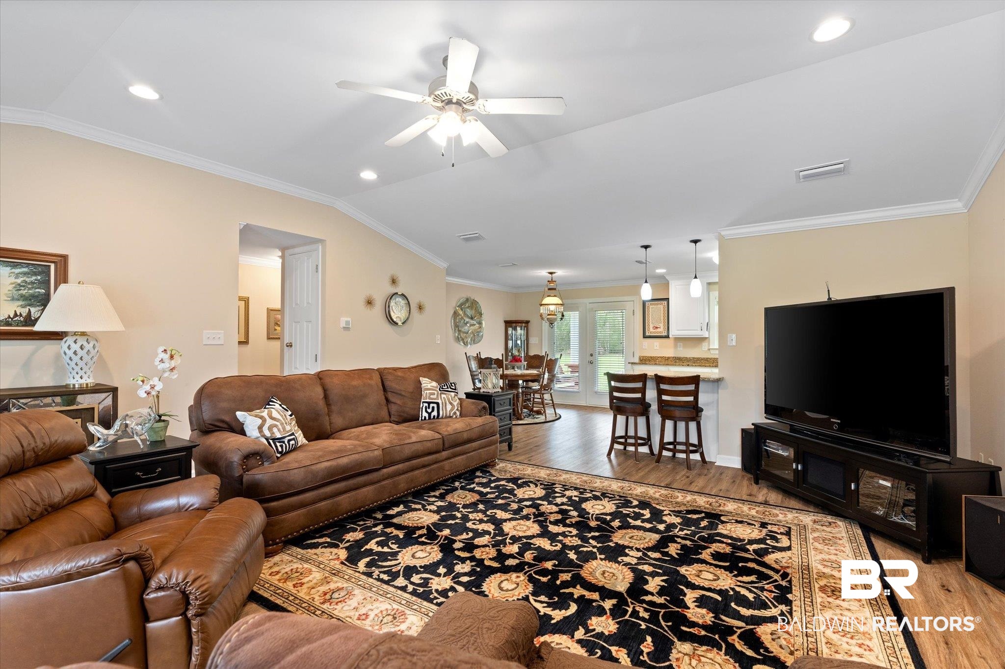734 West Section Avenue Foley, AL 36535 - Photo 6 of 50 Living area with lofted ceiling, crown molding, and light wood finished floors