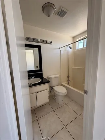 a bathroom with a toilet a sink and shower