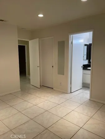 an empty room & kitchen view