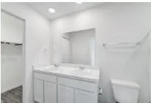 a bathroom with a sink toilet and vanity