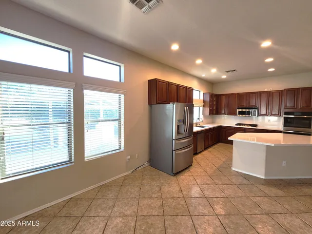 a kitchen with refrigerator and cabinets