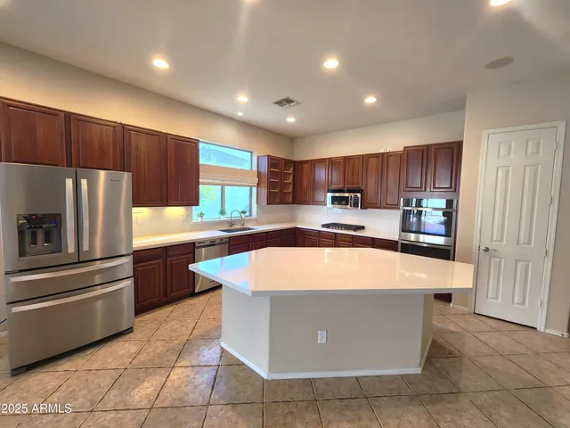 a kitchen with stainless steel appliances granite countertop a refrigerator oven a sink and dishwasher