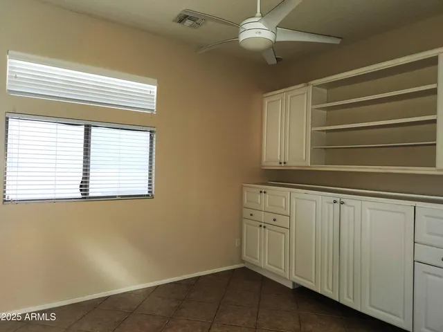 an empty room with windows and closet