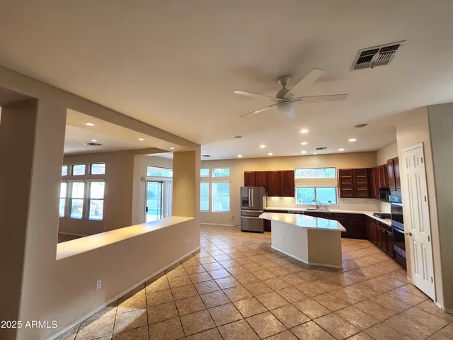 a view of a living room kitchen with stainless steel appliances granite countertop furniture and a view of kitchen