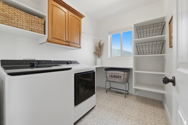 441 South 2080th Street East Springville, UT 84663 - Photo 25 of 64 Laundry area featuring patterned flooring, built-in shelving, wood-finish cabinetry, and a window providing natural light