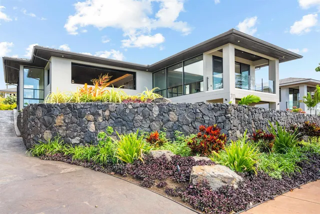 a front view of a house with a garden