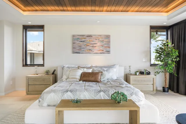 a bedroom with bed and a potted plant