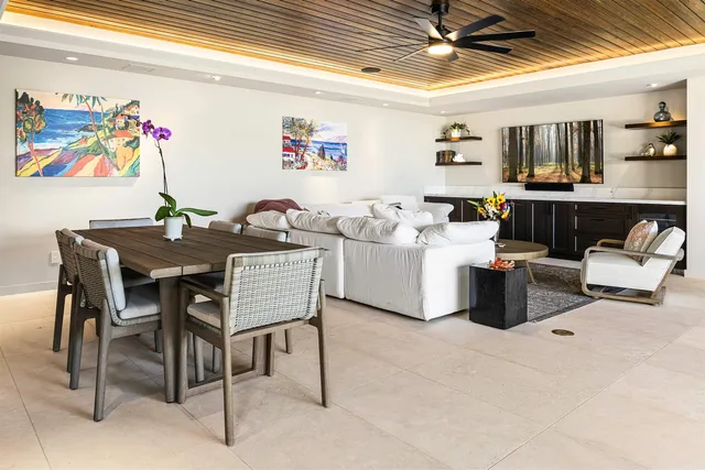 a view of a patio with table and chairs potted plants with wooden fence