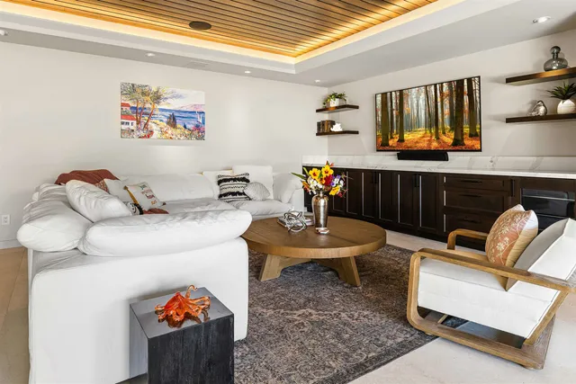 a kitchen with stainless steel appliances kitchen island a large tree in front of it