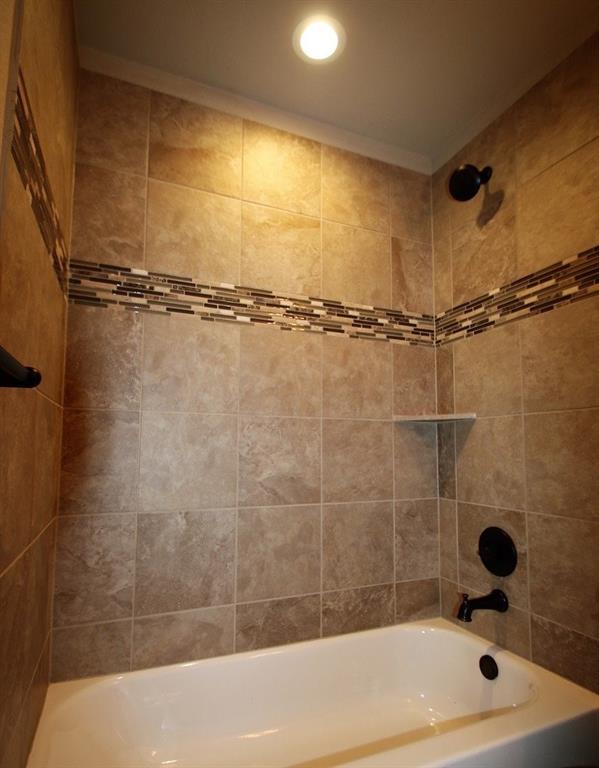 156 Crossbow Court Weatherford, TX 76088 - Photo 12 of 23 a bathroom with a bathtub and a shower