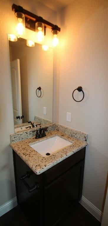 156 Crossbow Court Weatherford, TX 76088 - Photo 13 of 23 a bathroom with a granite countertop sink and a mirror