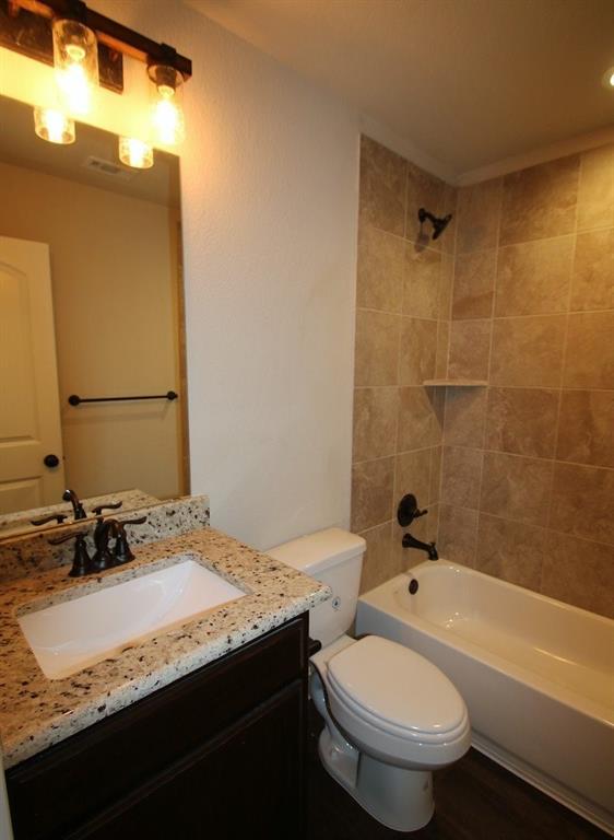 156 Crossbow Court Weatherford, TX 76088 - Photo 4 of 23 a bathroom with a granite countertop sink toilet and shower