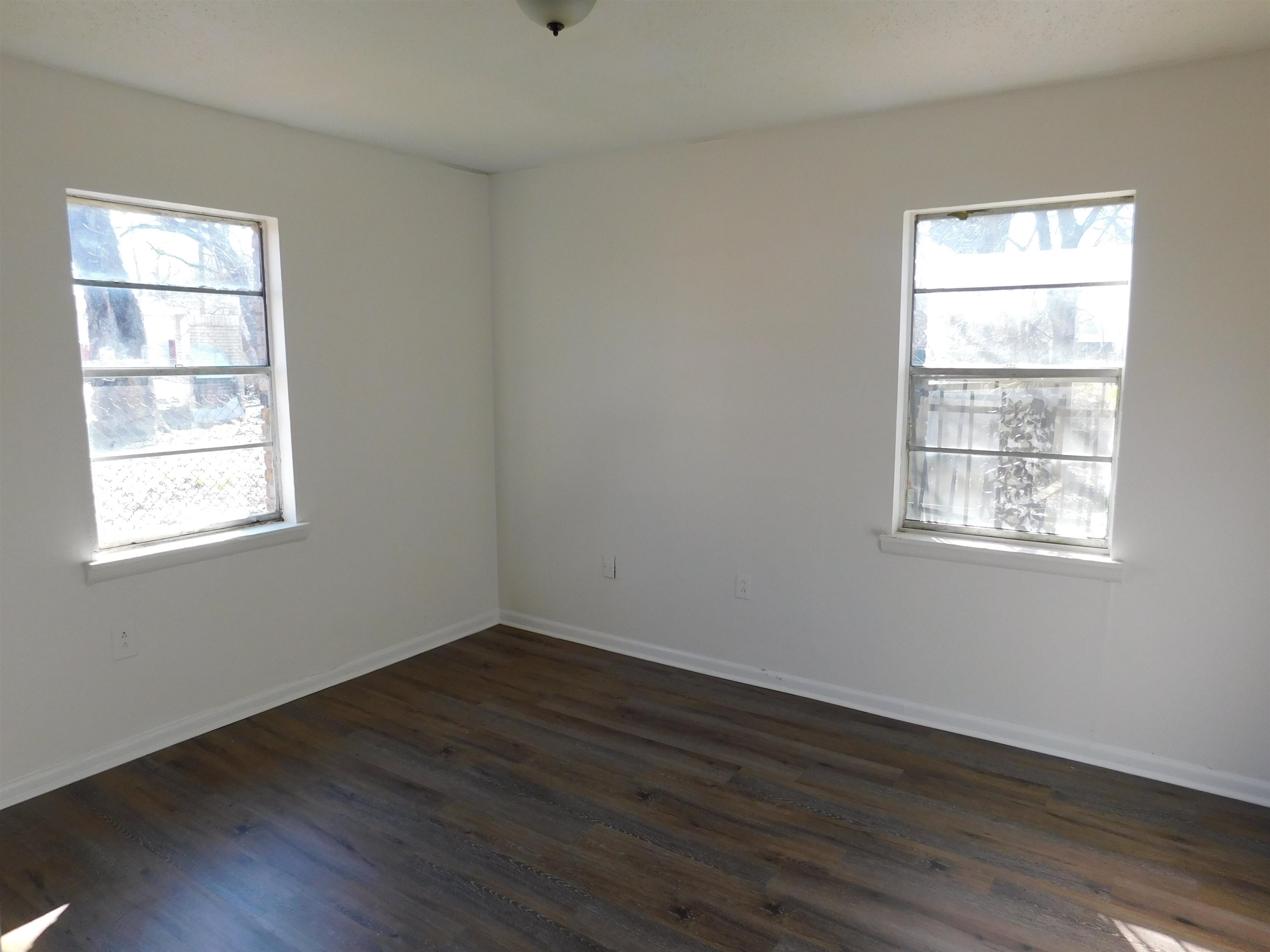 2367 Hubbard Avenue Memphis, TN 38108 - Photo 3 of 8 Unfurnished room featuring dark wood finished floors and baseboards