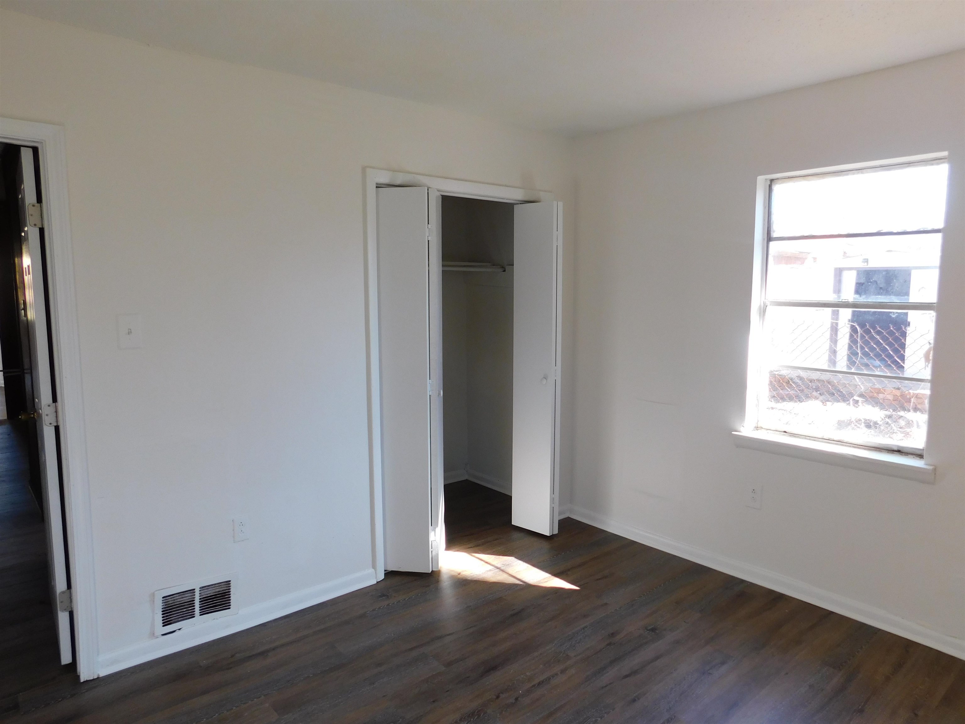 2367 Hubbard Avenue Memphis, TN 38108 - Photo 4 of 8 Unfurnished bedroom with dark wood-type flooring and a closet