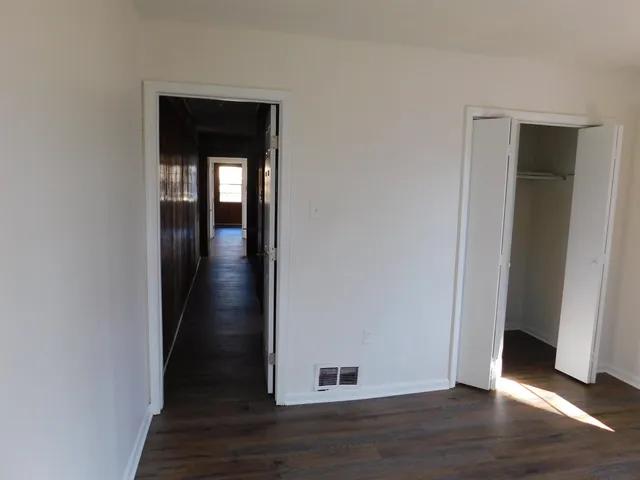 a view of a hallway with wooden floor