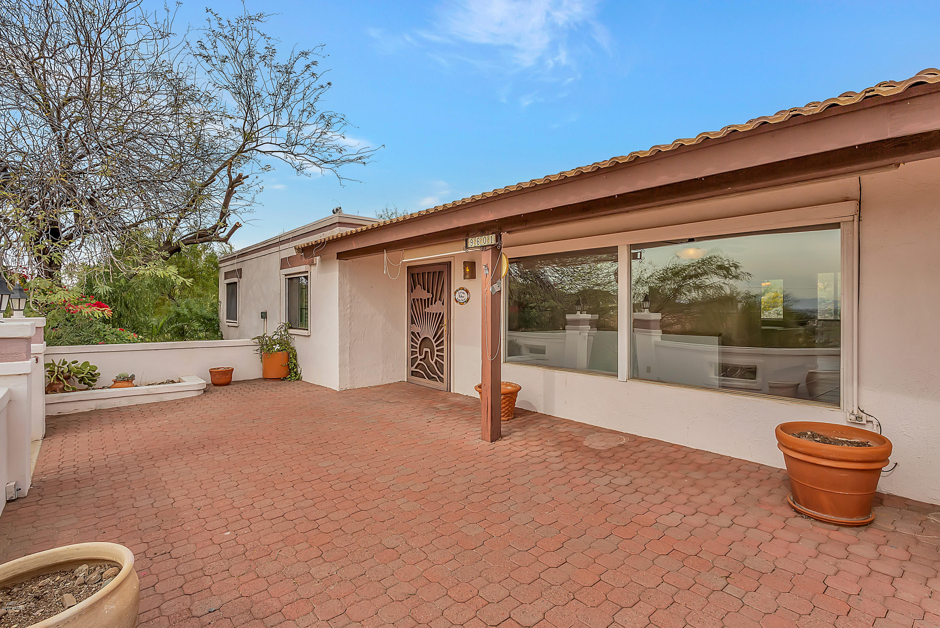 a backyard of a house with table and chairs