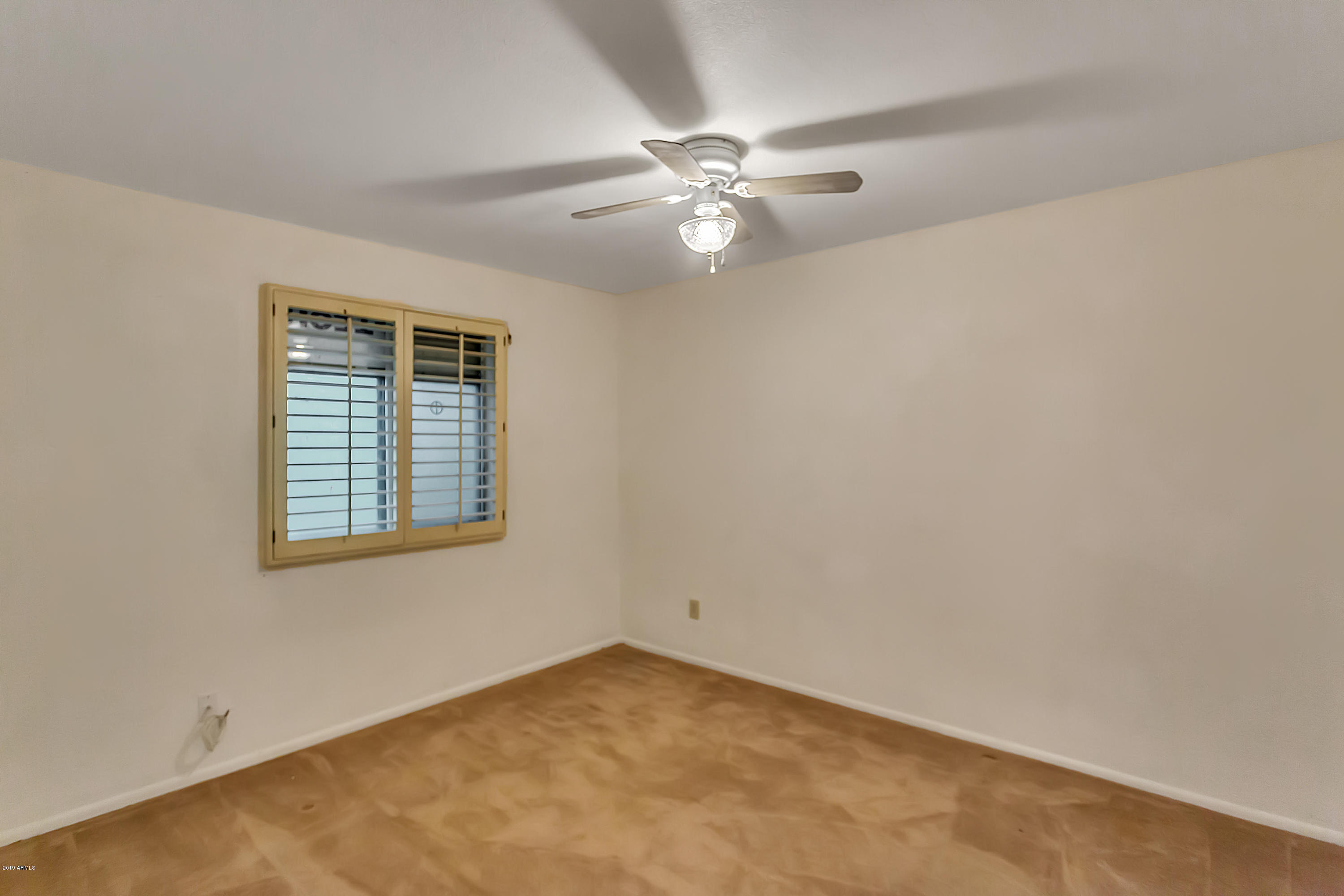 9601 North 17th Place Phoenix, AZ 85020 - Photo 11 of 16 an empty room with a window and a fan