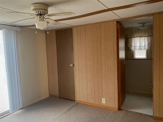 a view of a livingroom with a chandelier fan
