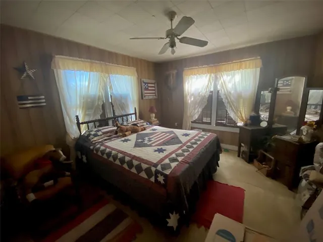 a living room with a bed and a mirror on a dresser