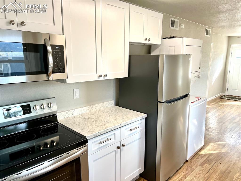734 East Rio Grande Street Colorado Springs, CO 80903 - Photo 13 of 30 a kitchen with a refrigerator stove and microwave