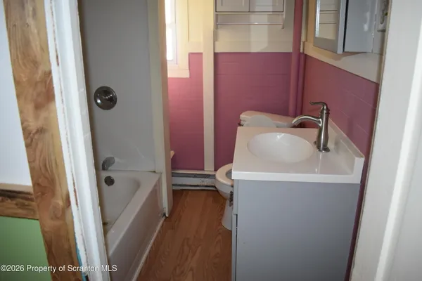 a bathroom with a sink a glass door shower and mirror