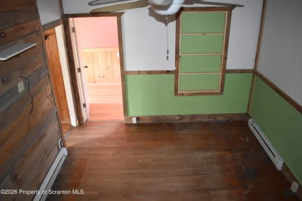 a view of a room with a refrigerator and a window