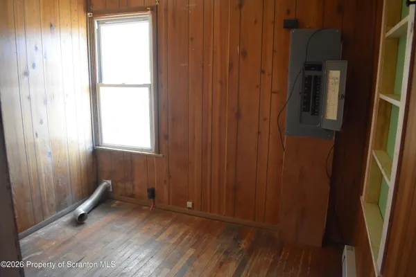 a view of an empty room with wooden door