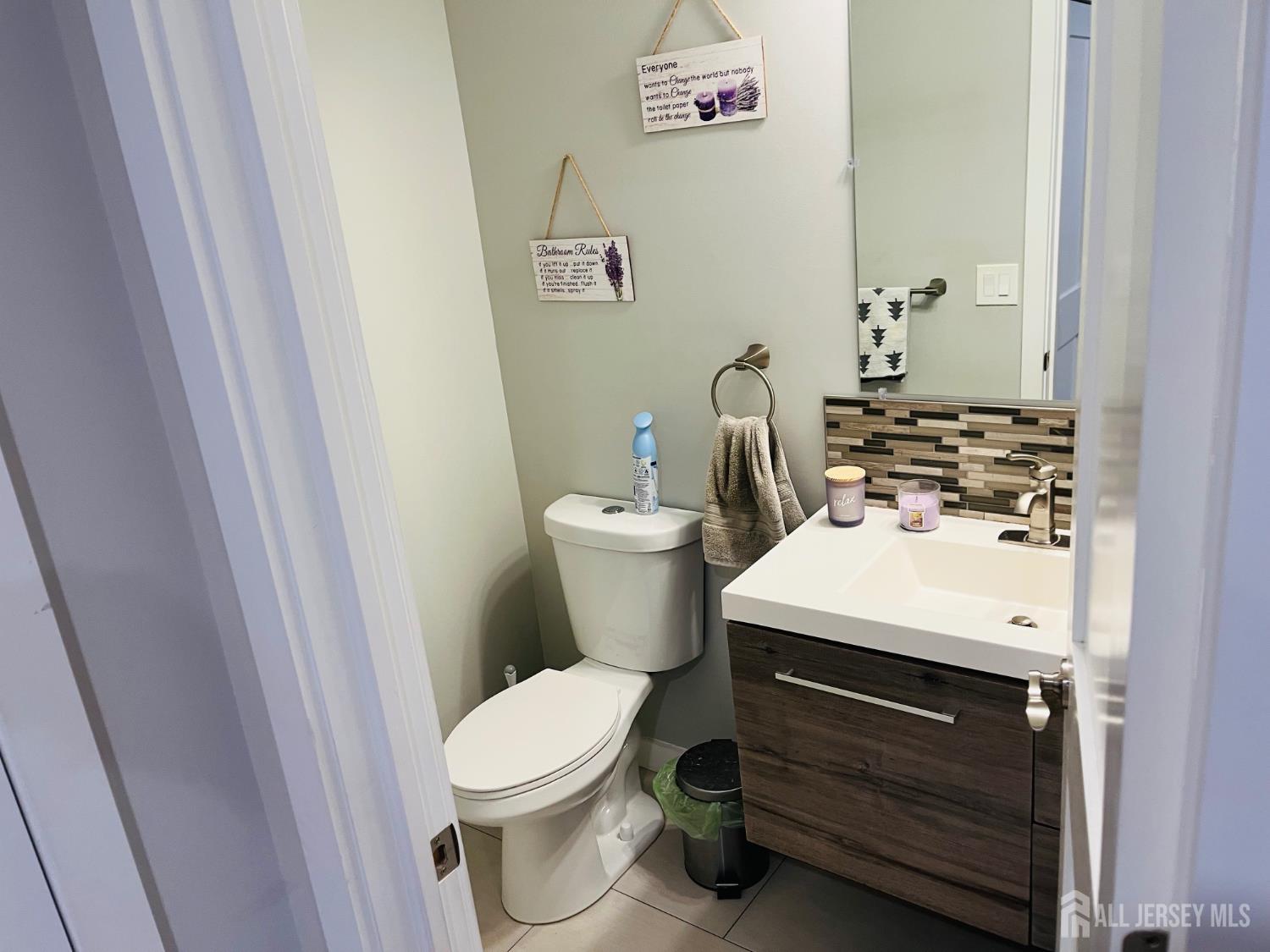566 Ticetown Road Old Bridge, NJ 08857 - Photo 2 of 23 a bathroom with a sink a toilet and a mirror