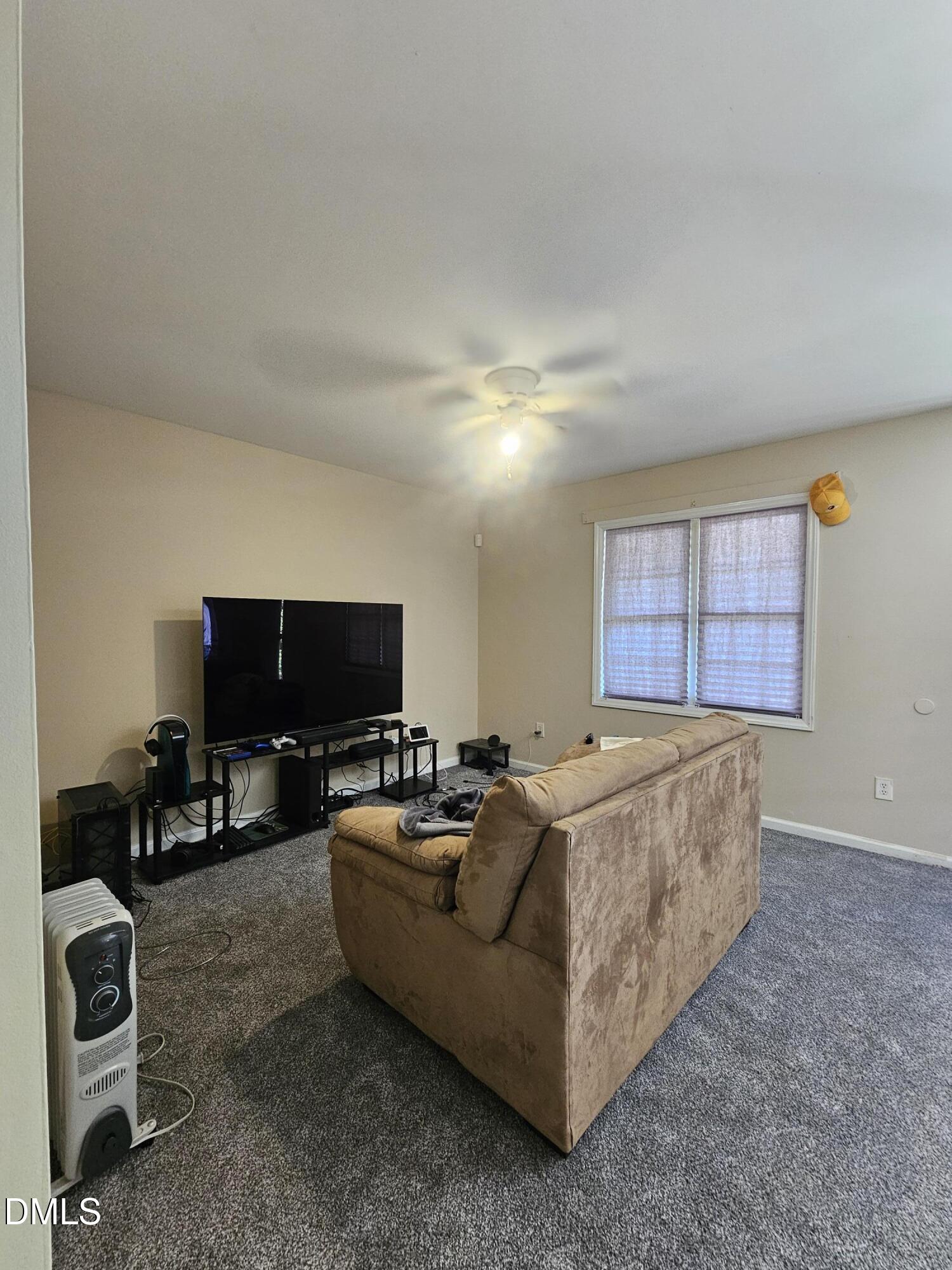 119 Lynn Drive Roxboro, NC 27573 - Photo 12 of 27 a living room with furniture and a flat screen tv