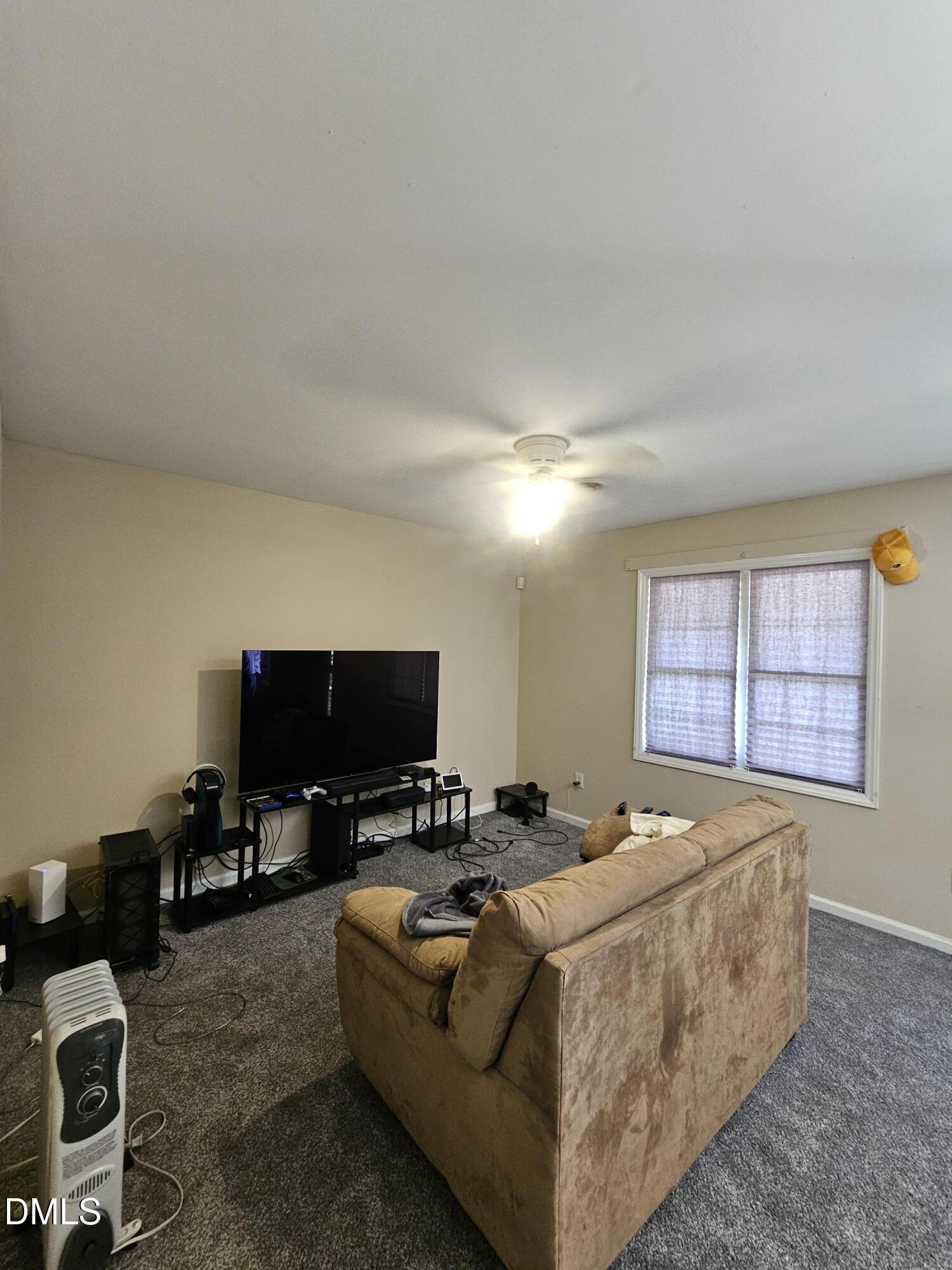 119 Lynn Drive Roxboro, NC 27573 - Photo 13 of 27 a living room with furniture and a flat screen tv