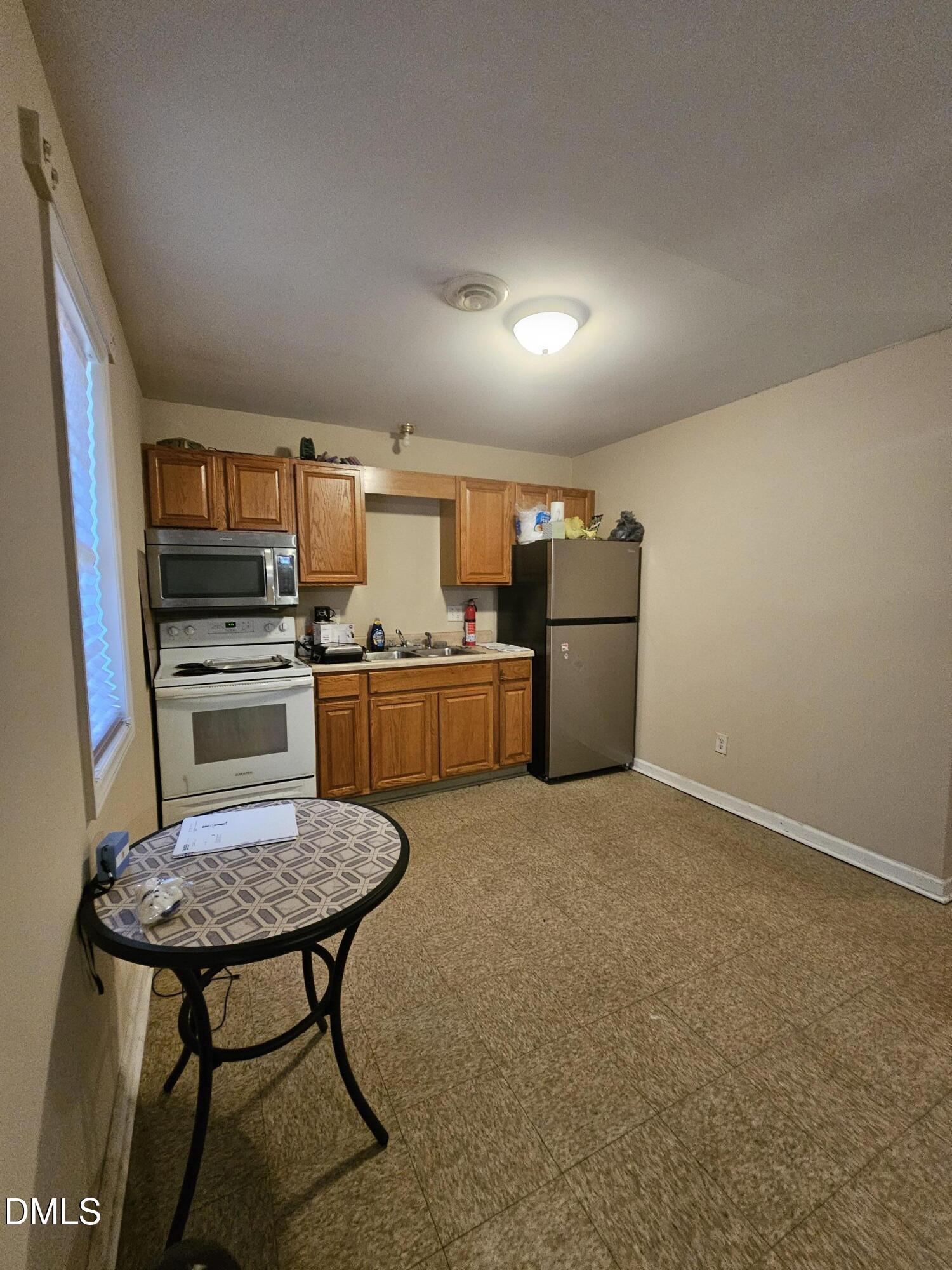 119 Lynn Drive Roxboro, NC 27573 - Photo 16 of 27 a kitchen with a table and chairs in it