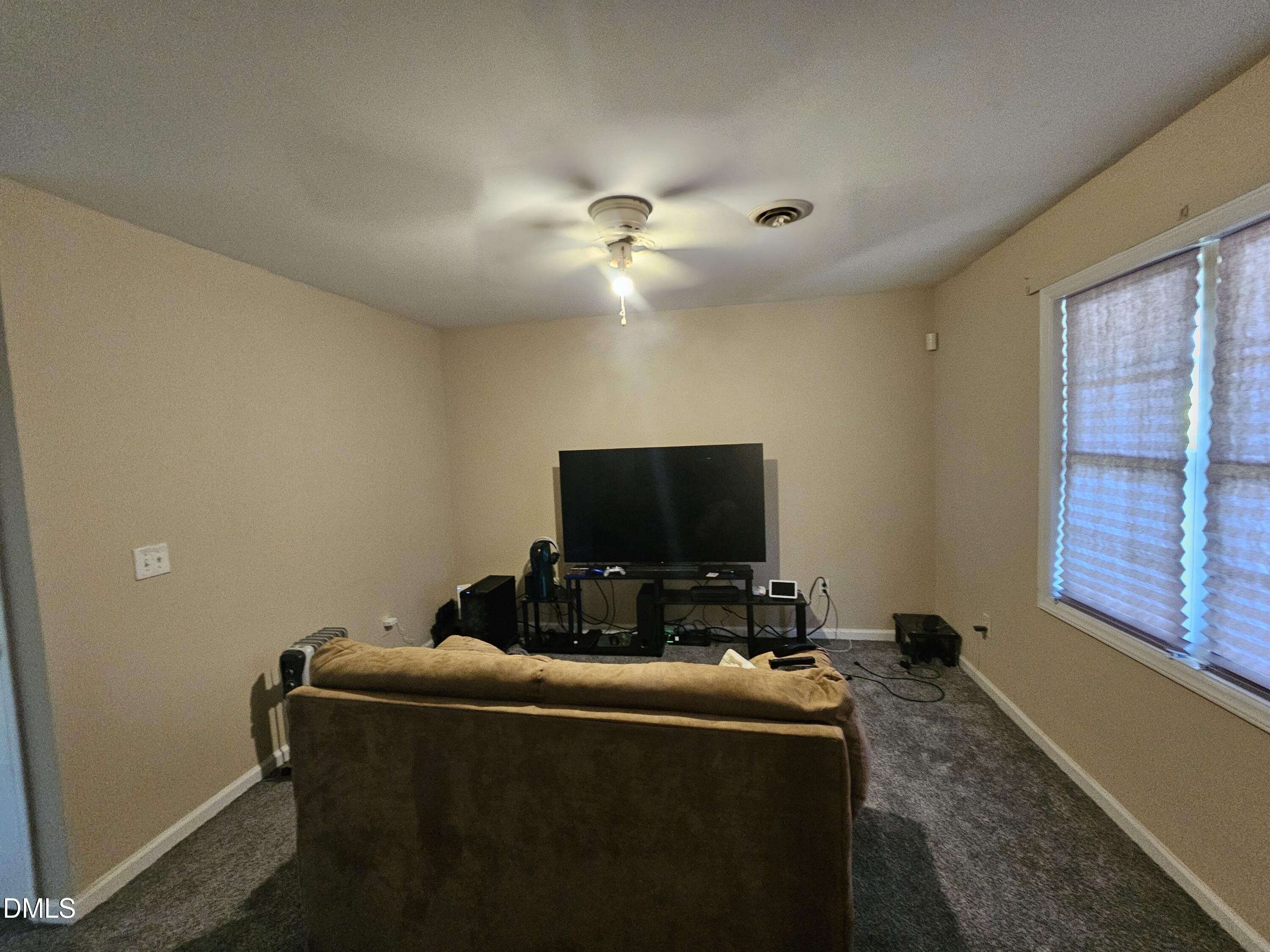 119 Lynn Drive Roxboro, NC 27573 - Photo 17 of 27 a living room with furniture and a flat screen tv