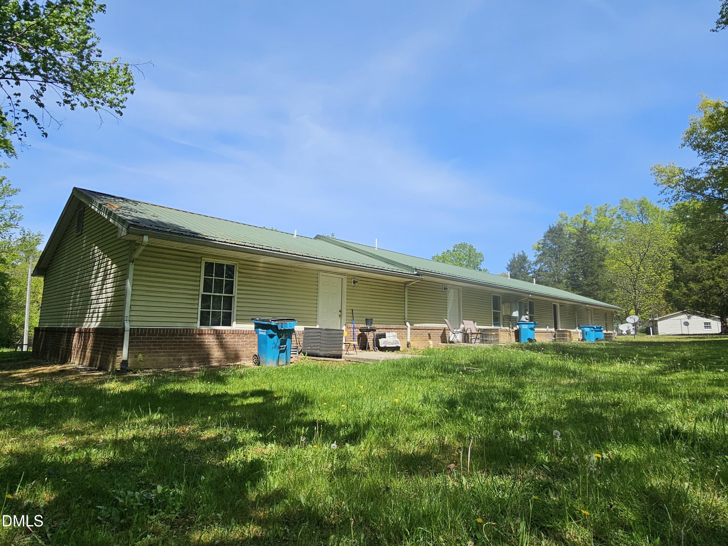 119 Lynn Drive Roxboro, NC 27573 - Photo 20 of 27 a front view of house with yard and outdoor seating